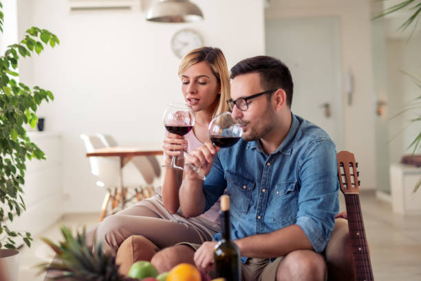 istock Cheerful young couple celebrating at home 1134836360