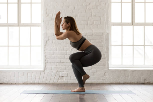 istock Beautiful woman practicing yoga, standing in Eagle pose, Garudasana 1134840976