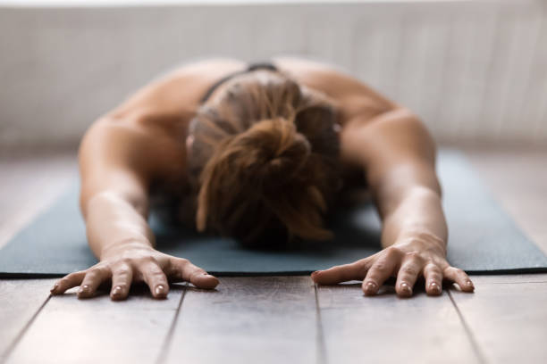istock Young woman practicing yoga, relaxing after training, lying face down 1134841009