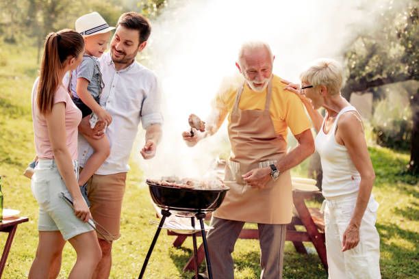 istock Happy family having barbecue party in backyard 1134841157