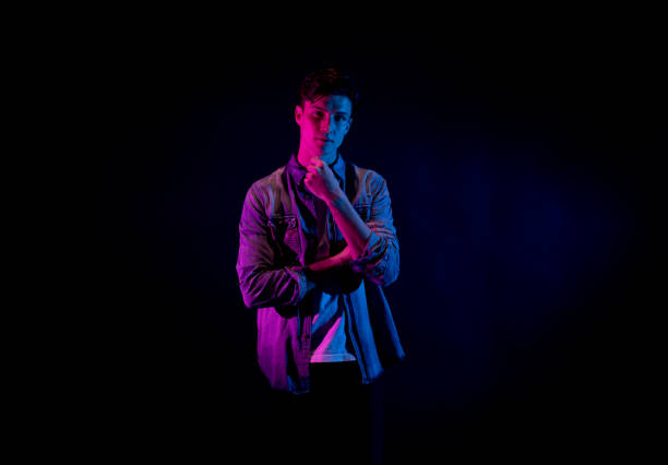 istock Good looking man wearing a button down shirt in front of black background 1134841174
