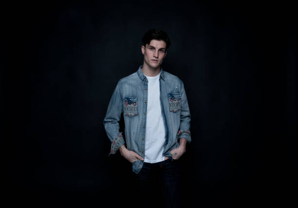 istock Good looking man wearing a button down shirt in front of black background 1134841268