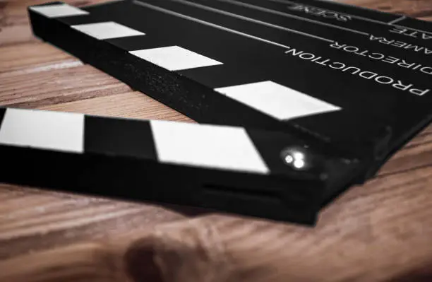 Selective focus of a Clapper board on a wood surface, cinema and videomaking concep