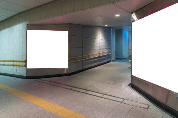 istock Walkway with Blank billboard located in underground hall or subway for advertising, mockup concept, Low light speed shutter 1134842385