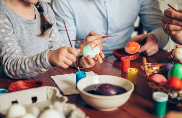 Happy family painting Easter eggs