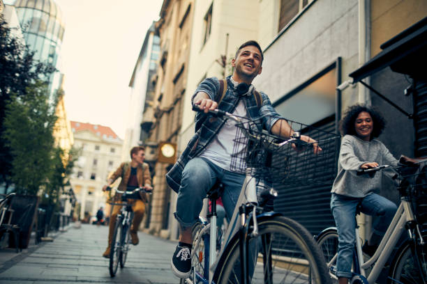 istock Friends Riding Bicycles In A City 1134846995