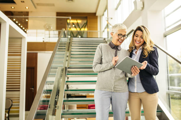 istock Businesswomen working together with digital tablet and smiling 1134850374