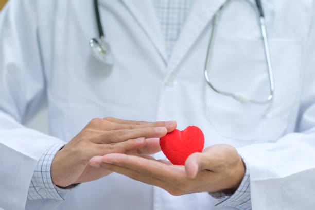 istock Midsection Of Doctor Holding Red Heart Shape 1134851529