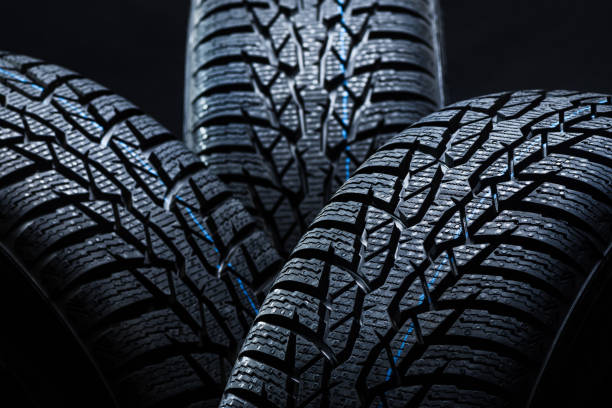 istock Winter tyres on black background with contrasty lighting 1134851856