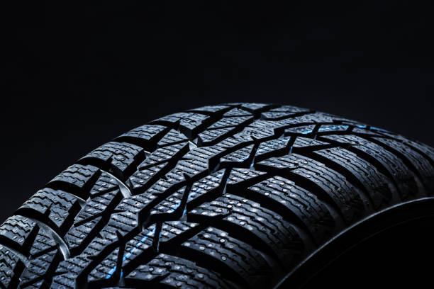 istock Winter tyres on black background with contrasty lighting 1134851918