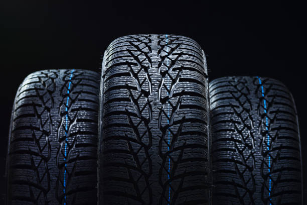 istock Winter tyres on black background with contrasty lighting 1134852044
