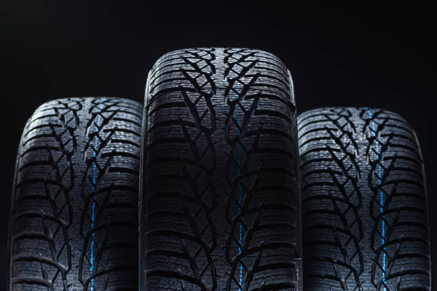istock Winter tyres on black background with contrasty lighting 1134852150