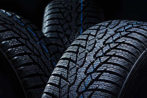 istock Winter tyres on black background with contrasty lighting 1134852217