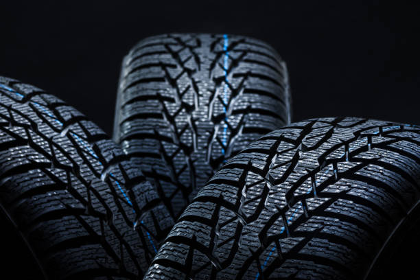 istock Winter tyres on black background with contrasty lighting 1134852262