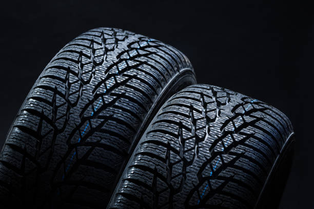 istock Winter tyres on black background with contrasty lighting 1134852305