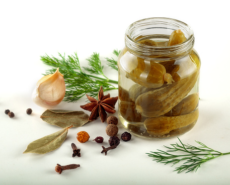 pickled, marinated vegetables in glass cann isolated white background