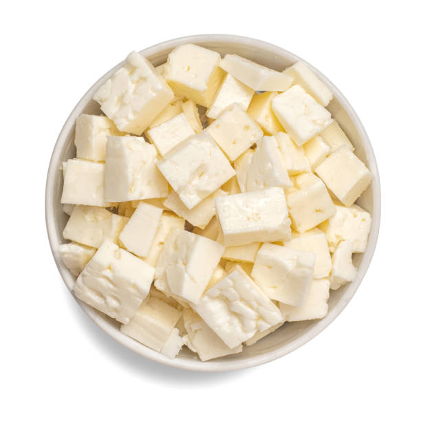 Sliced feta cheese in bowl isolated on white background. Top view Sliced feta cheese in bowl isolated on white background. Top view. feta cheese block stock pictures, royalty-free photos & images