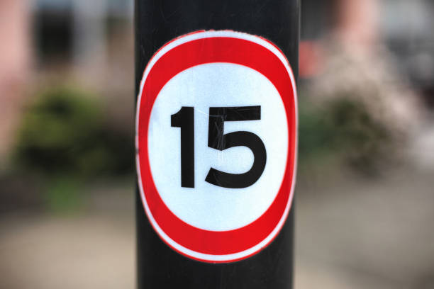 Speed limit road sign against blue sky with clouds, 60 km maximum driving in a street