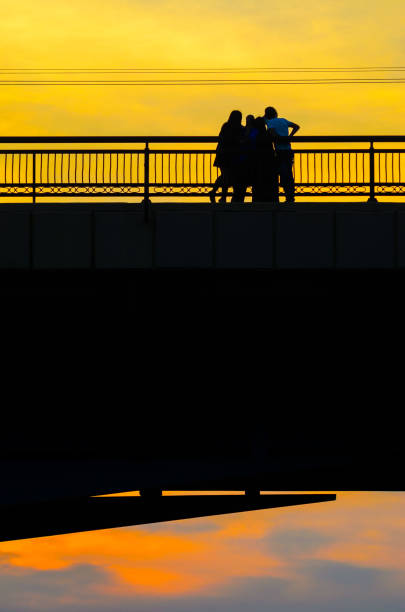 istock Silhouettes a Group of People on the High Bridge 1134862992