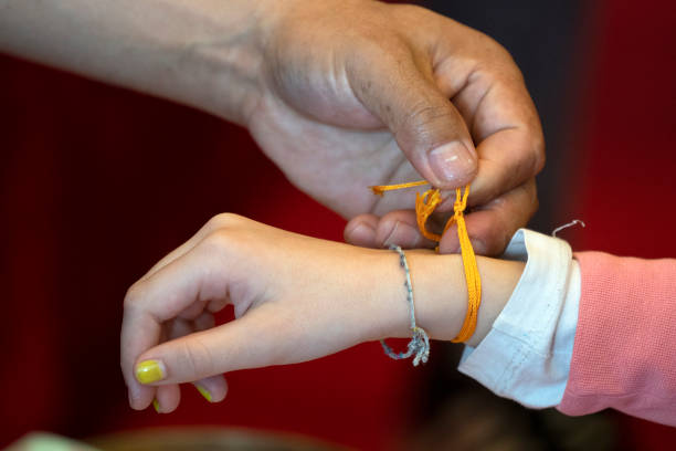 istock Tibetan monk while putting bracelet on buddihst hand 1134868686