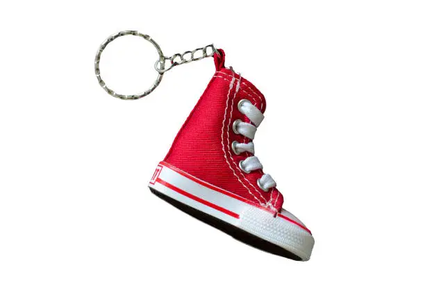 Key chain with mini red basketball shoe on white background