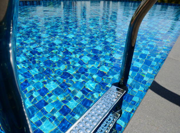 istock Chairs and swimming pool with steel ladder 1134874722