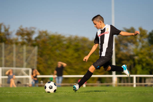 istock professional junior soccer player outdoors free kick 1134877463