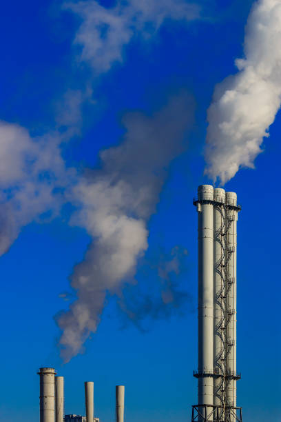 istock White smoke goes from a pipe on a background of blue cloudless sky 1134877908