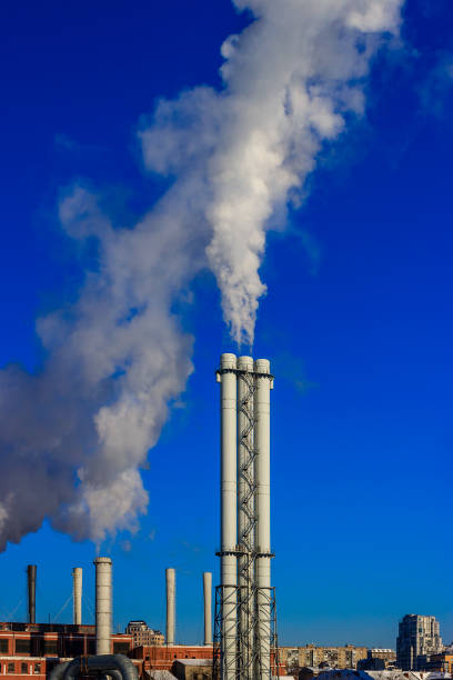 istock White smoke goes from a pipe on a background of blue cloudless sky 1134879181