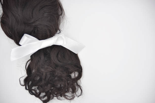istock Dark brown curly hair with white lace on the white background 1134879343