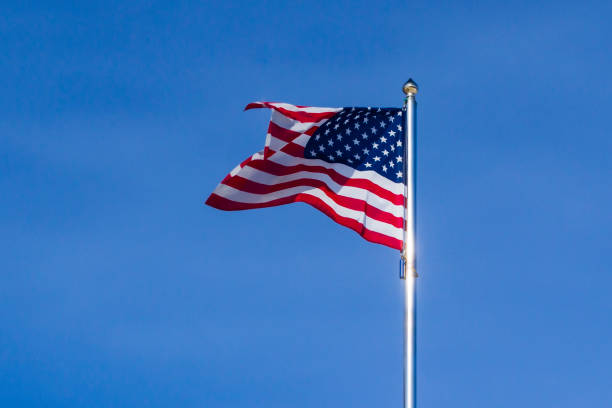 istock US flag flutters in the wind against the cloudless sky 1134880266