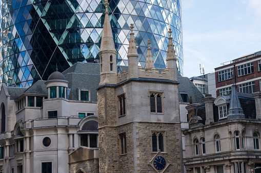 Skyscraper rises above the old historic buildings in City of London
