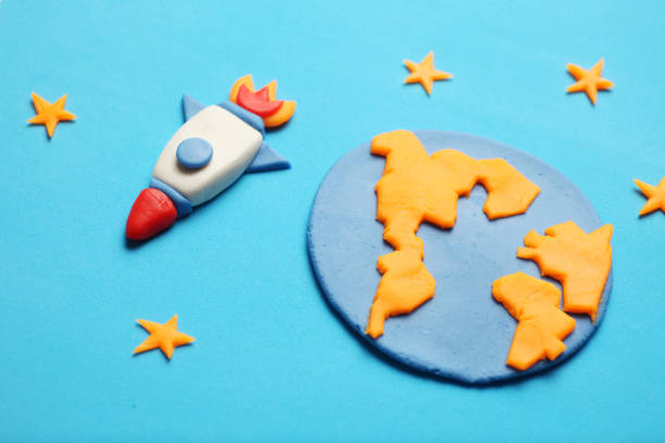 istock Creative craft plasticine rocket in open space, astronaut dreams. Stars, planet earth. Cartoon art 1134880851