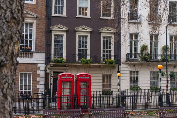 Britain's classic red telephone boxes in Mayfair, London The red telephone box, a telephone kiosk for a public telephone designed by Sir Giles Gilbert Scott, is a familiar sight on the streets of the United Kingdom, Malta, Bermuda and Gibraltar Mayfair stock pictures, royalty-free photos & images