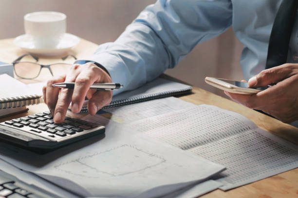 istock businessman working on desk in office using calculator and mobile 1134883978