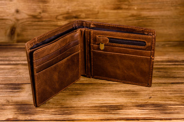 istock Opened brown leather wallet on wooden table 1134884903