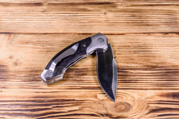 istock Opened folding knife on a wooden table 1134884912