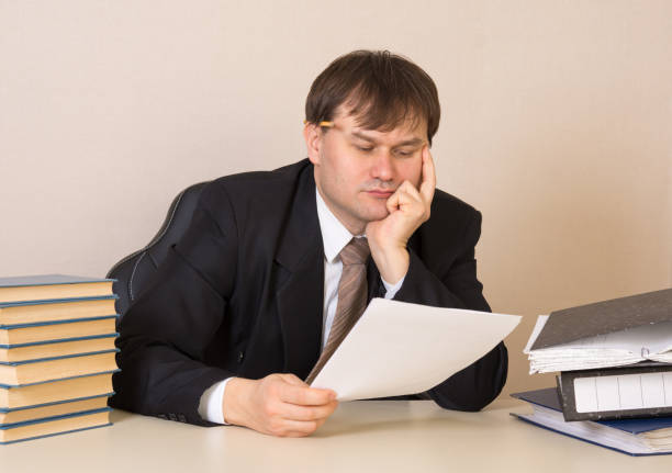 istock The employee thought about the document at the table in the office 1134885089