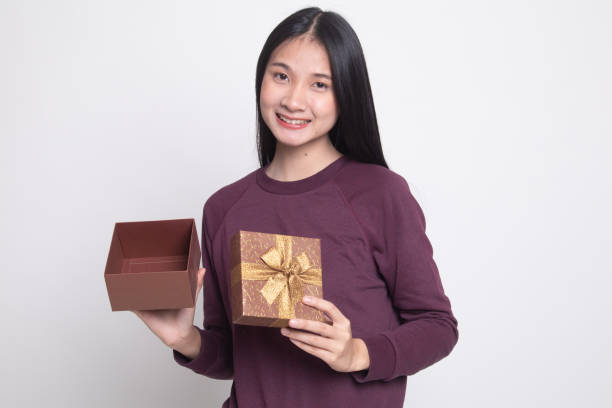 istock Young Asian woman open a golden gift box. 1134888734