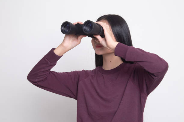 istock Young Asian woman with binoculars. 1134889131