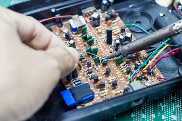 istock Technician repairing electronic of the computer's circuit board by soldering Irons 1134889863