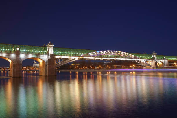 istock Moskva River in the lights reflections and Andreevsky (Pushkinsky) pedestrian bridge at spring night time. 1134890111