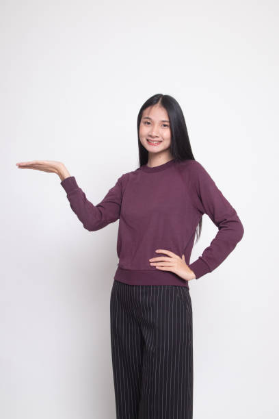 istock Young Asian woman present with her hand. 1134890135