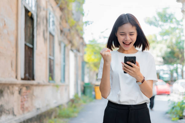 istock Woman using smartphone for the application and showing a happy gesture. Concepts for digital technology in everyday Life 1134890325
