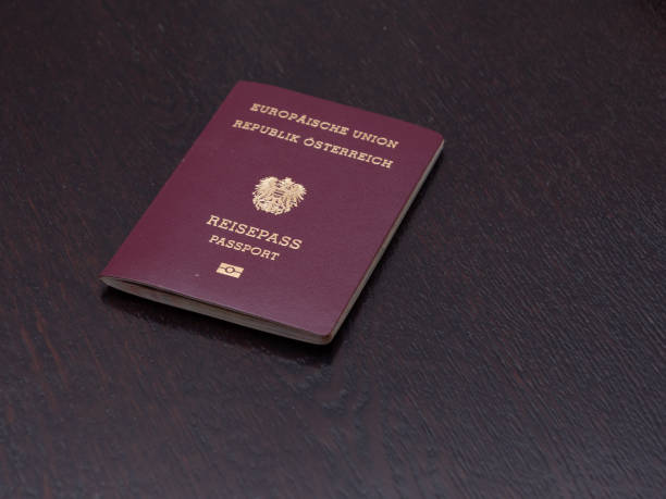 European Passport of Austrian Nationality Red European Passport of Austrian Nationality on a Wooden Table austrian culture photos stock pictures, royalty-free photos & images