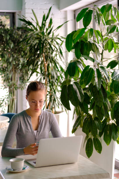 istock The girl works at the computer in a cafe 1134895400