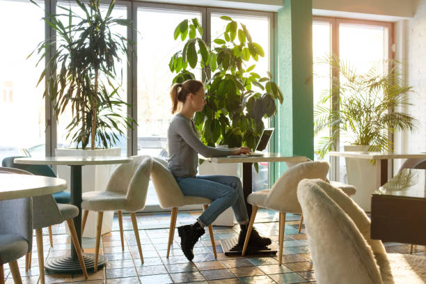 istock The girl works at the computer in a cafe 1134895490
