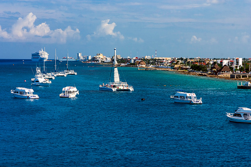 Scene with Pleasure Boats, Catamarans, Cruise Ships and the Coastline are all visible while Cruising into Cozumel Mexico