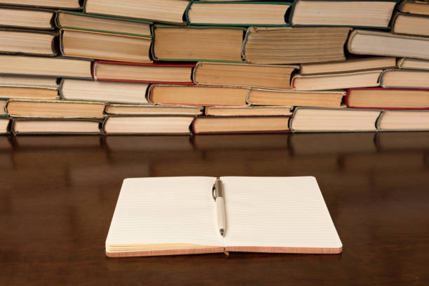 istock notebook and pen on the background of books 1134900080