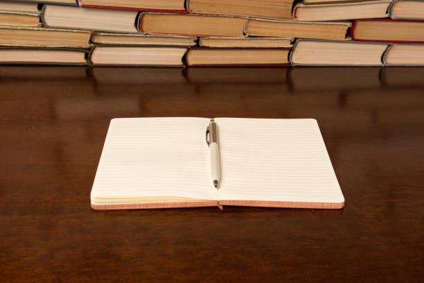 istock notebook and pen on the background of books 1134900081